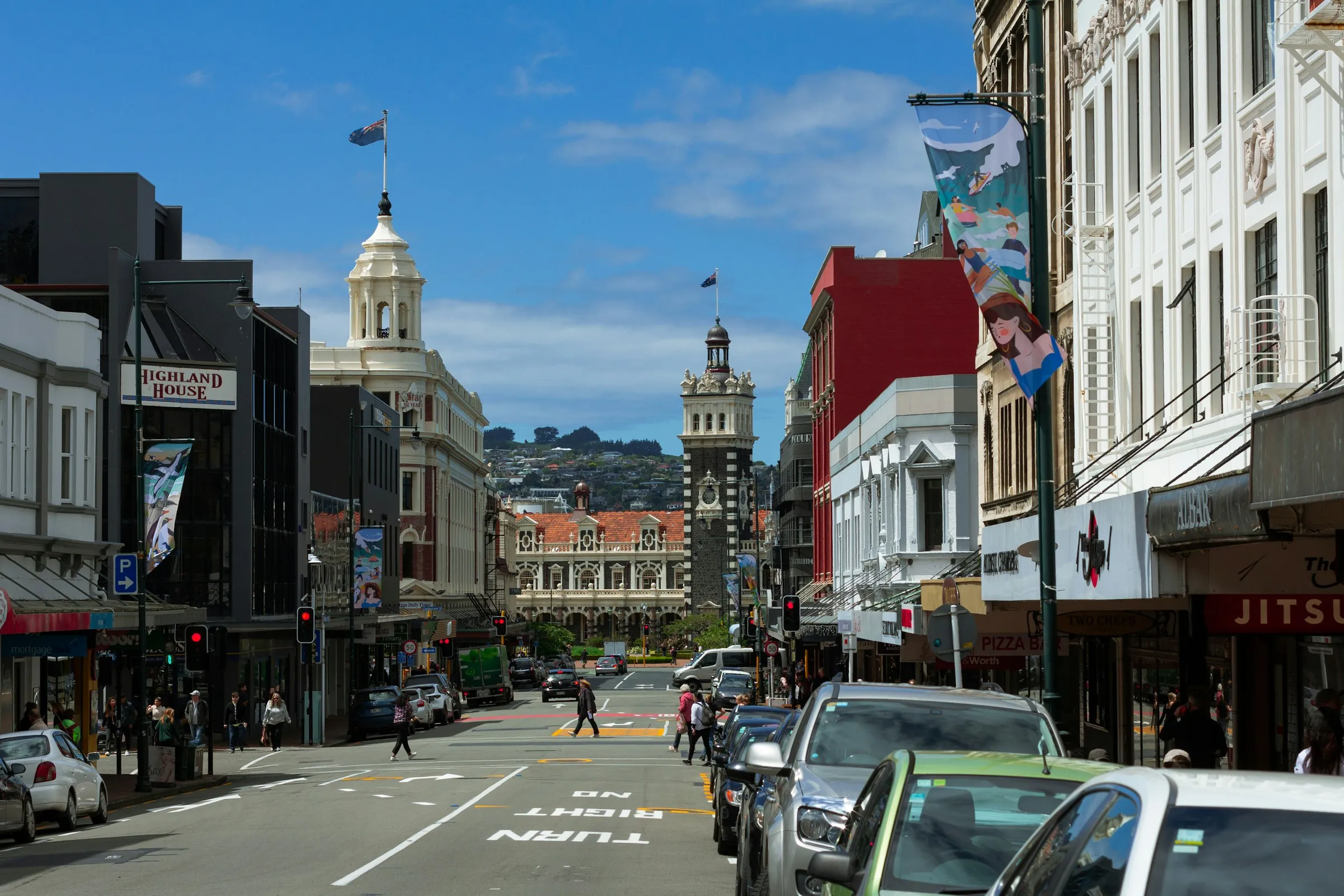 A Dunedin city street lined with historic buildings on a sunny day